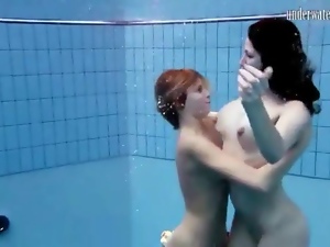 Two cute naked girls go swimming