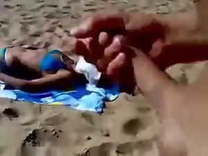Guy jerking to unknowing woman on beach