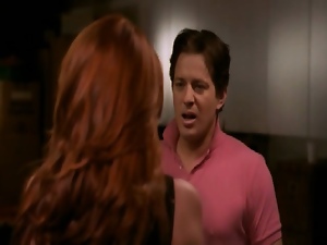 Angie Everhart wearing a black tanktop as a guy runs his