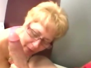 Mature granny wearing spex sucking on cock